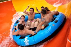 Small Group of people riding down a water slide