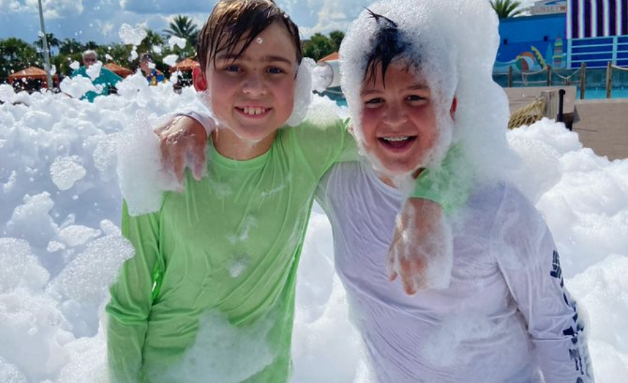 A Full Season of Island Getaway: Water Attractions, Great Food, & Live Entertainment 5 two kids enjoying a foam party at island h20