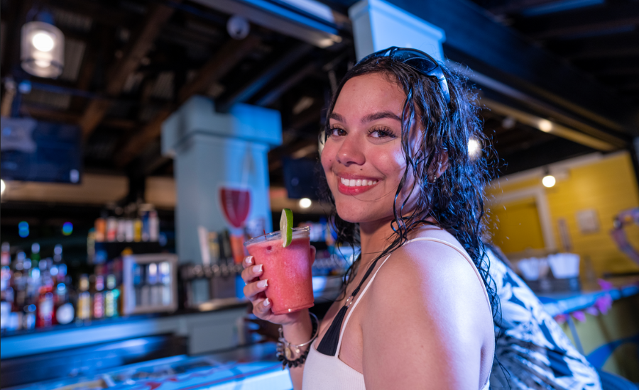 a woman having a drink at island h20