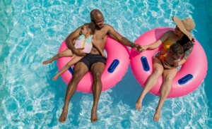 a family enjoying the pool on a summer day at island h20