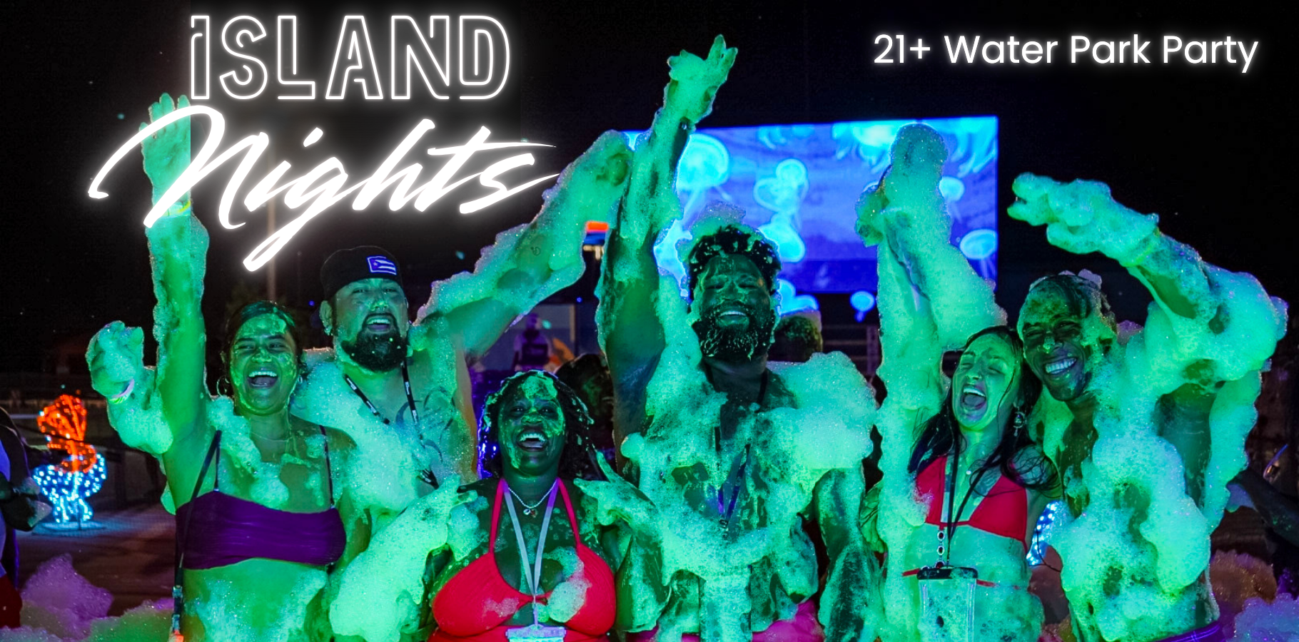 Family of four laughing on a water slide raft inside a tunnel with swirling rainbow lights.